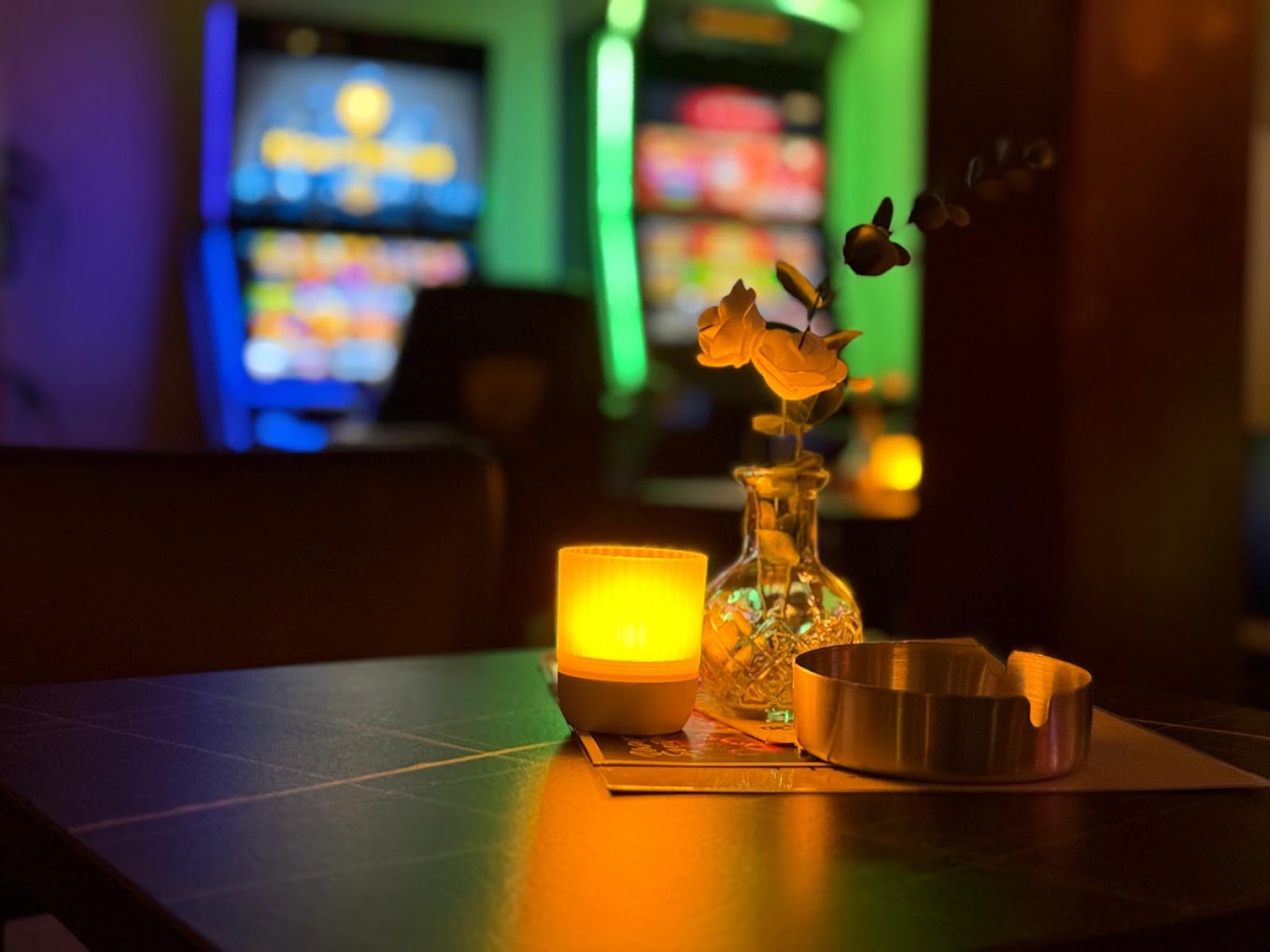 Gemütliche Ecke mit Kerzenlicht und Spielautomaten im Point Cafe Bar